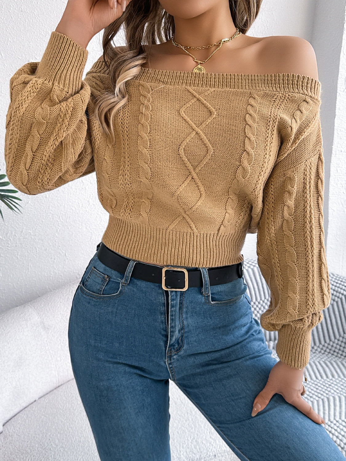 Camel cable knit off-shoulder crop sweater with balloon sleeves and diamond pattern.