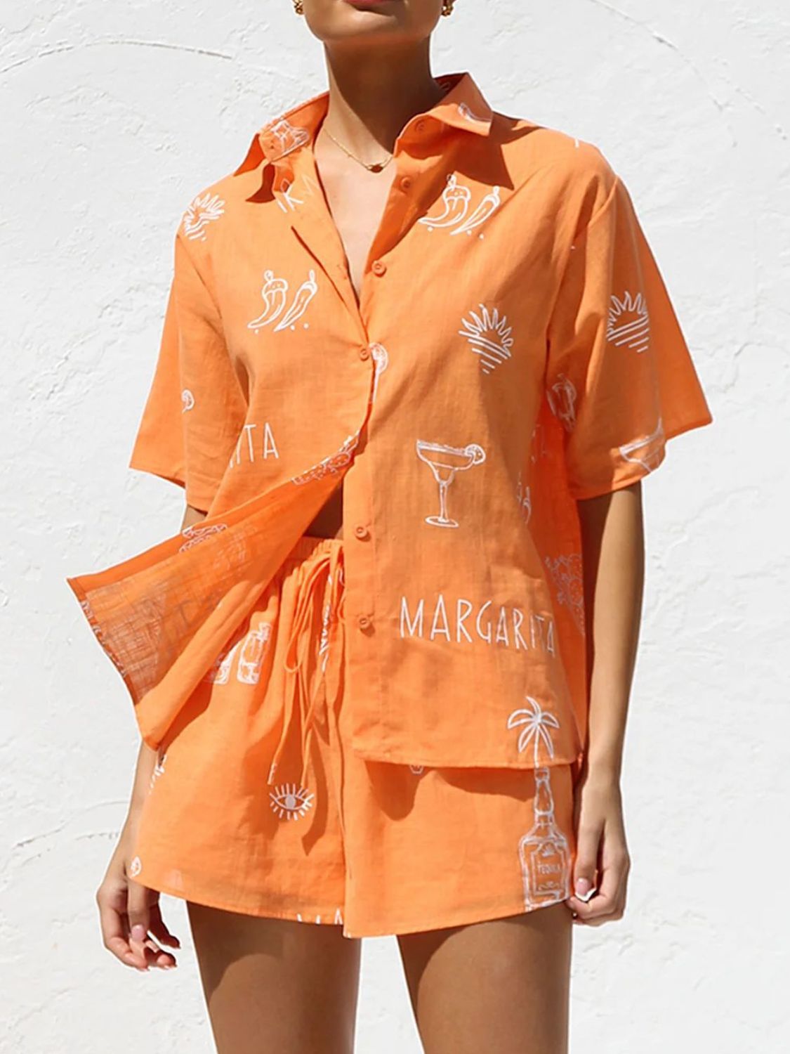 Orange button-up resort shirt and shorts set with white margarita and chili pepper print.