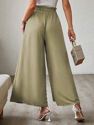 Paperbag waist palazzo pants in Matcha Green with side slits and a textured finish.