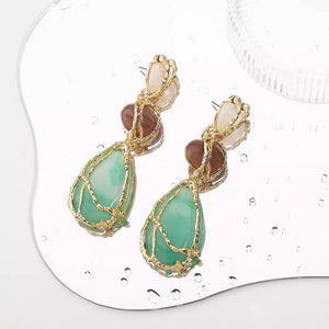 Elegant teardrop dangle earrings in gold-plated finish with green and brown stones.