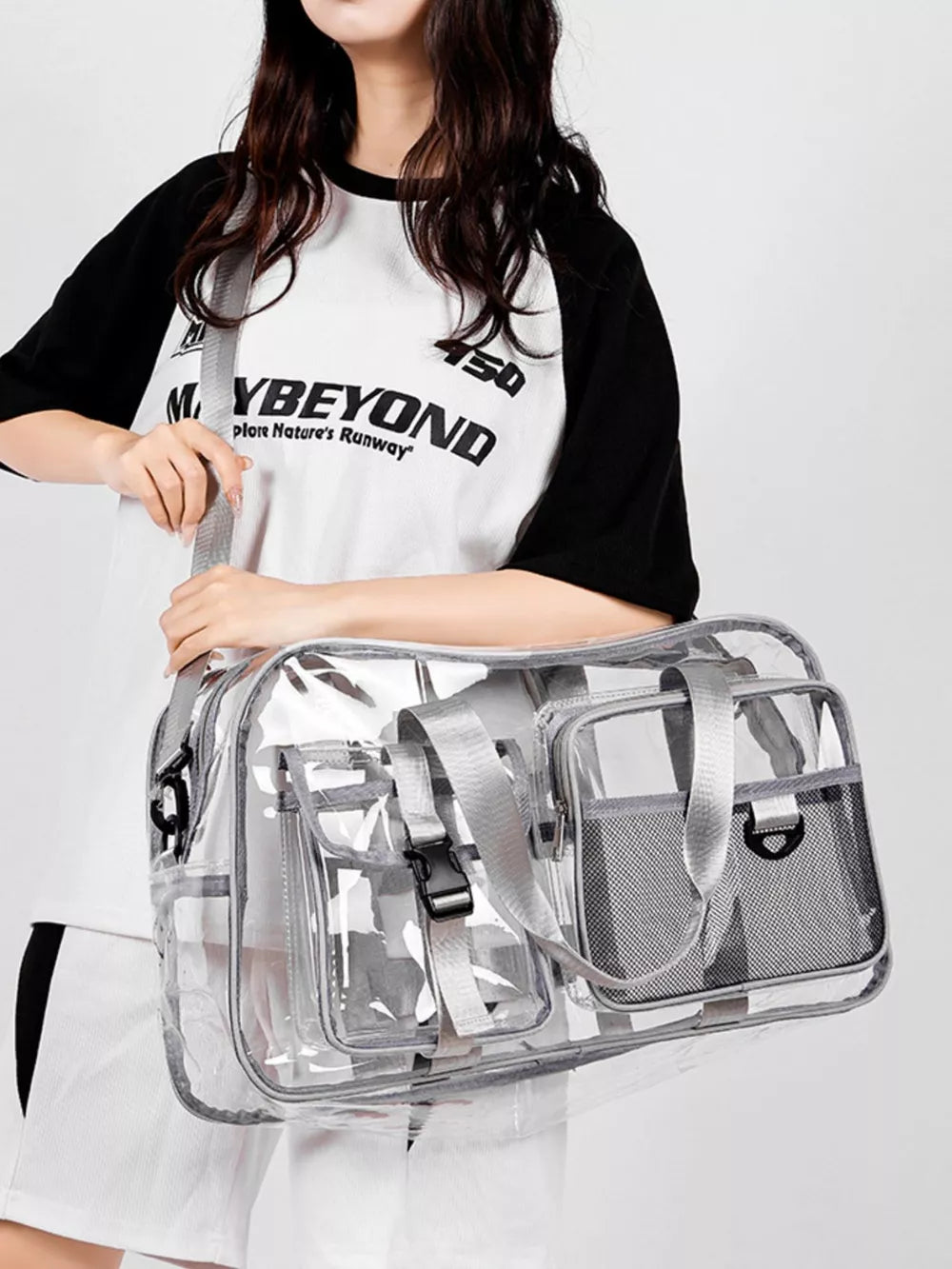 Sleek transparent travel duffel bag with grey accents and multiple pockets.