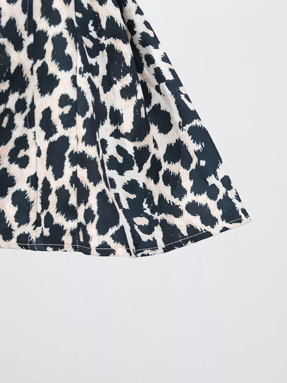 Leopard print mini dress with halter neck detail and cutout accents.
