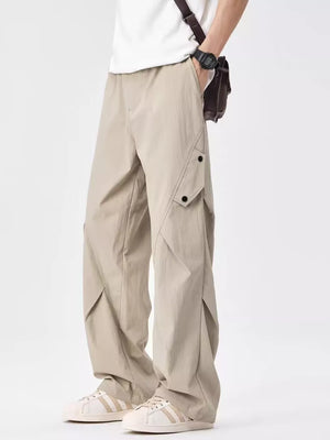 Light apricot relaxed fit cargo sweatpants with flap pockets and button details.