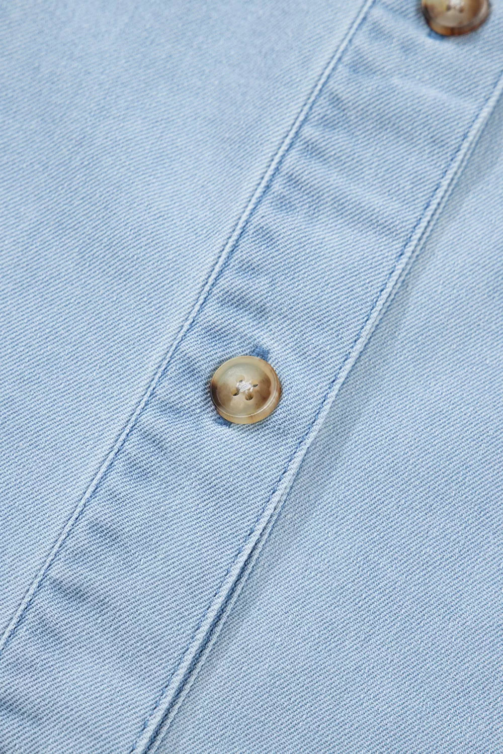 Light wash denim shift dress with button detail and visible stitching.