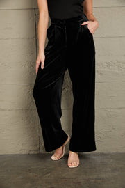 Black velvet palazzo trousers with high waist and wide leg