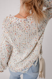Confetti knit sweater in white with colorful flecks, distressed hem, and frayed neckline.