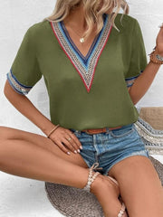 Matcha green v-neck top with embroidered trim on neckline and sleeves