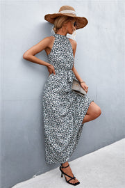 Black floral print maxi dress with halter neckline and tie waist.