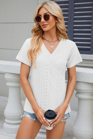 White eyelet wrap V-neck top with short sleeves and a casual fit.