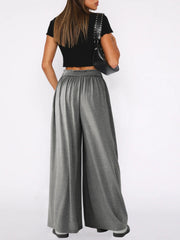 Gray jersey wide-leg trousers with elastic waistband and drape front detail.
