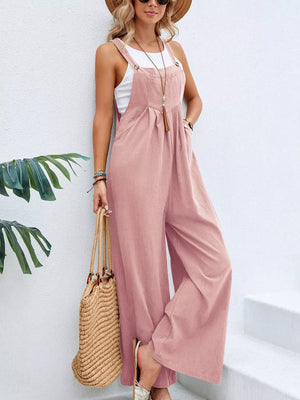 Pink wide-leg romper with pockets, adjustable straps, and button details.