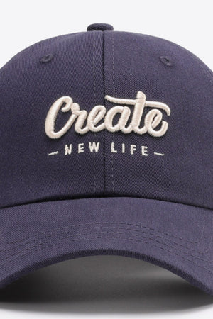 Navy baseball cap with embroidered "Create New Life" text detail