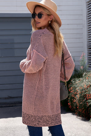 Pink textured puff sleeve open cardigan with a contrasting hem.