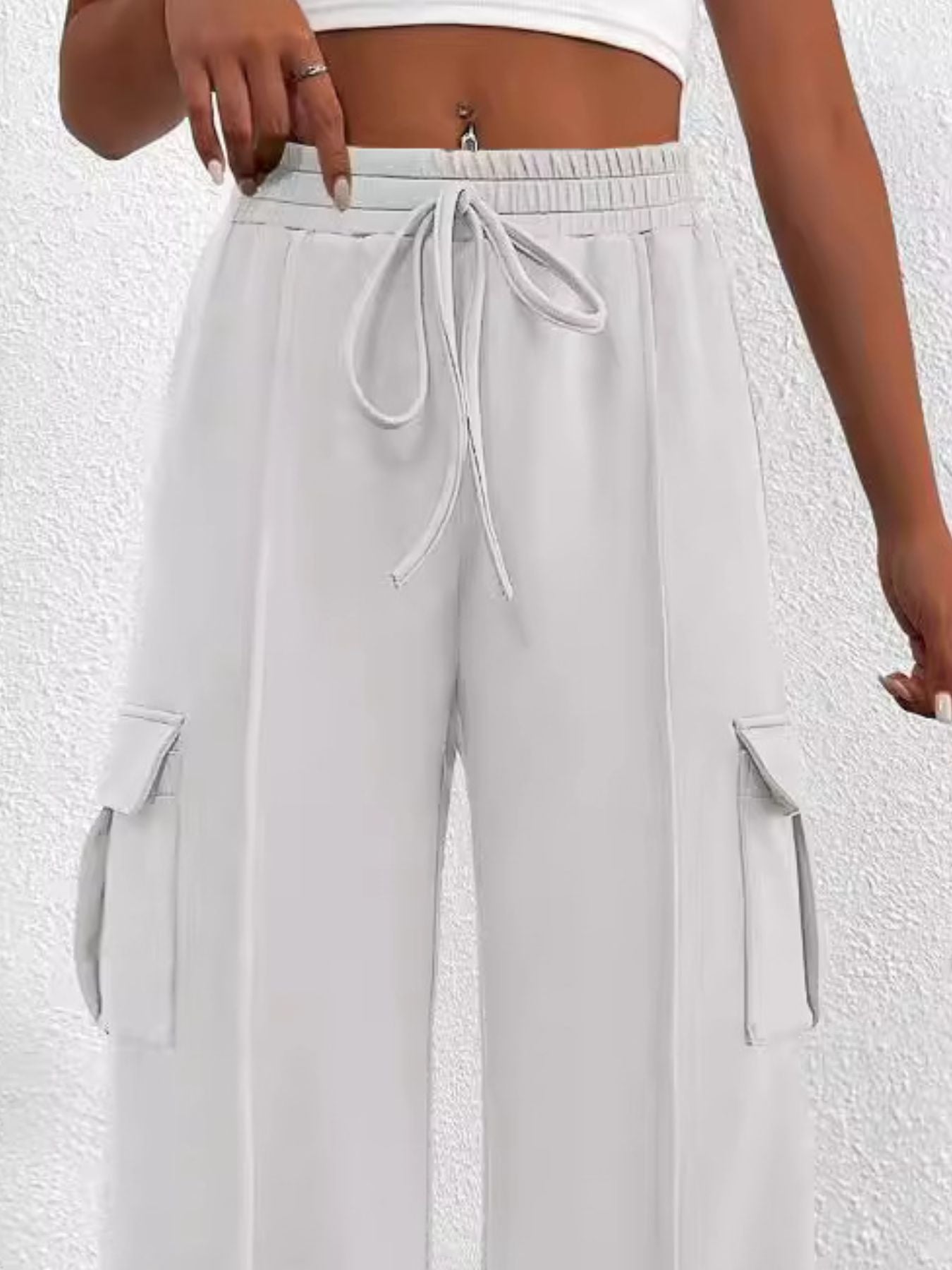 Gray high waist cargo sweatpants with drawstring and side pockets.