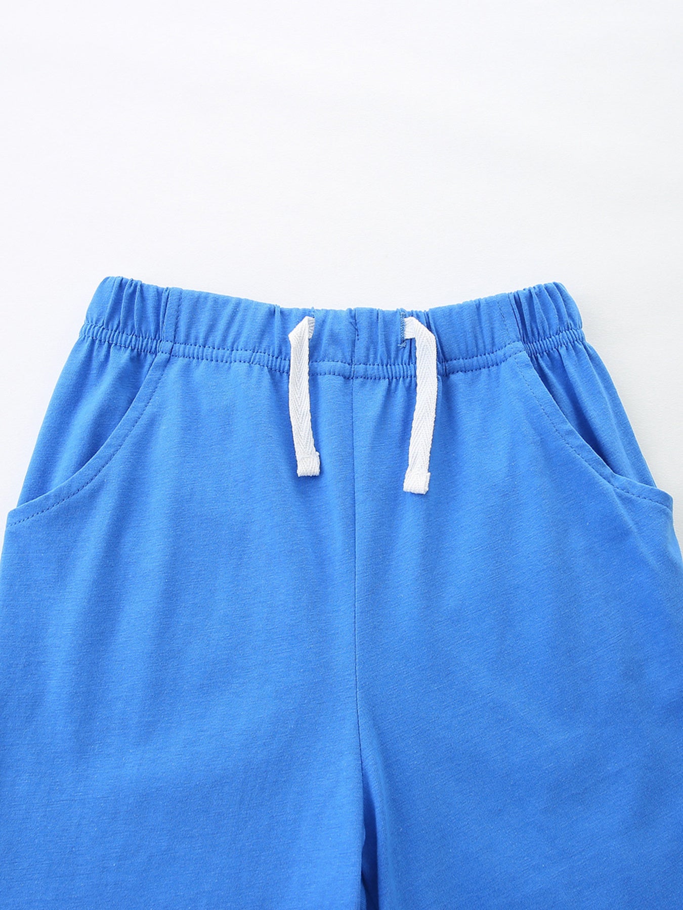 Blue cotton toddler shorts with elastic waistband and white drawstring.
