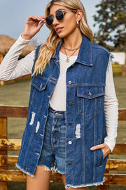 Distressed denim sleeveless jacket in dark wash with frayed hem and distressed details.