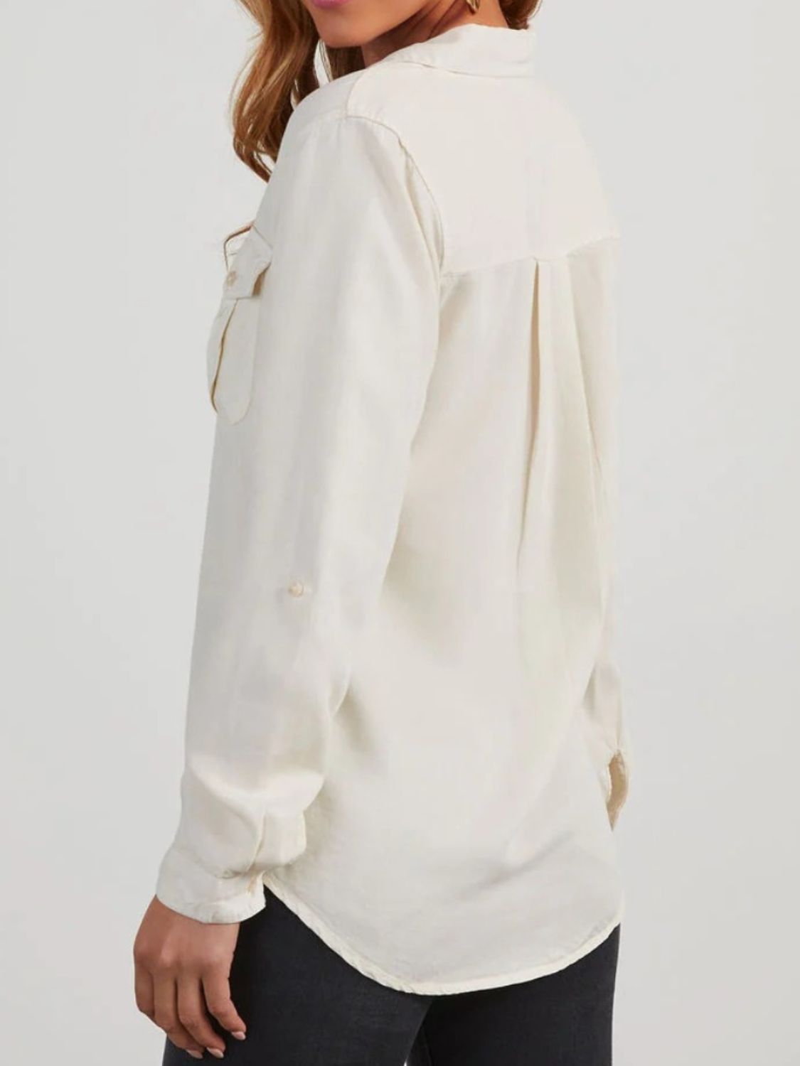Washed denim utility shirt in white with buttoned chest pockets and roll-tab sleeves.