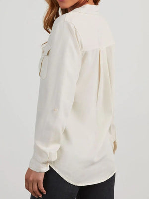Washed denim utility shirt in white with buttoned chest pockets and roll-tab sleeves.