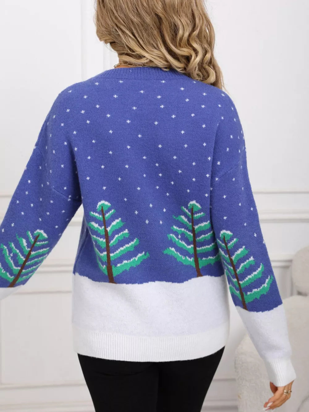 Blue acrylic sweater with evergreen trees and snow pattern, long sleeves, crew neck.