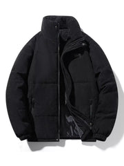 Black corduroy puffer jacket with high collar and zip closure.