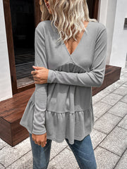 Light gray waffle knit peplum top with V-neck and tiered ruffle hem.