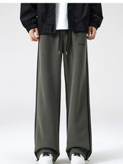 Gray green sweatpants with black side stripes and drawstring waist.