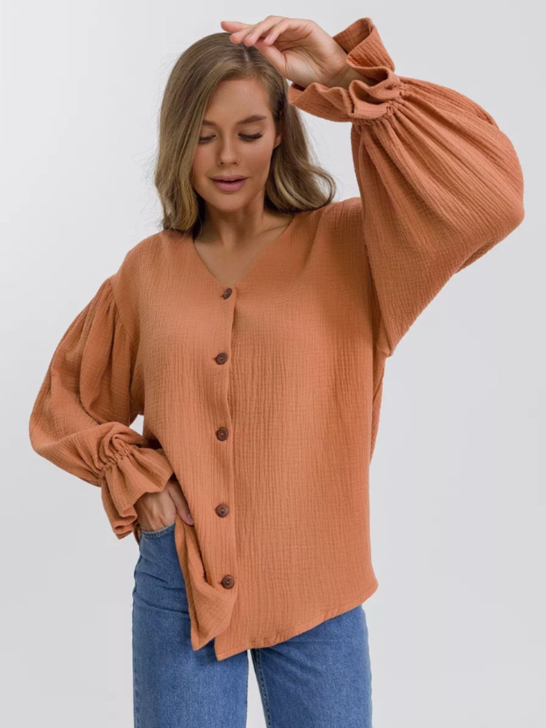 Ochre textured puff sleeve blouse with ruffled cuffs and button-down front.