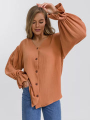 Ochre textured puff sleeve blouse with ruffled cuffs and button-down front.