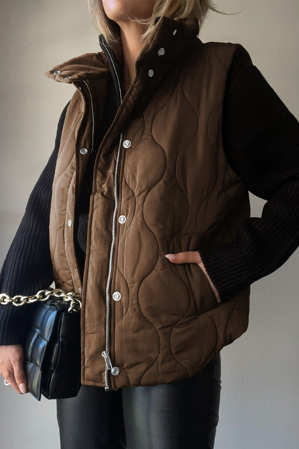 Quilted stand-collar utility gilet in taupe with snap and zip front closure.