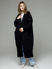 Black oversized ribbed-trim maxi cardigan with pockets, styled with a white tee and jeans.