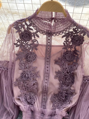 Purple lace blouse with floral embroidery and sheer sleeves, paired with a cami.