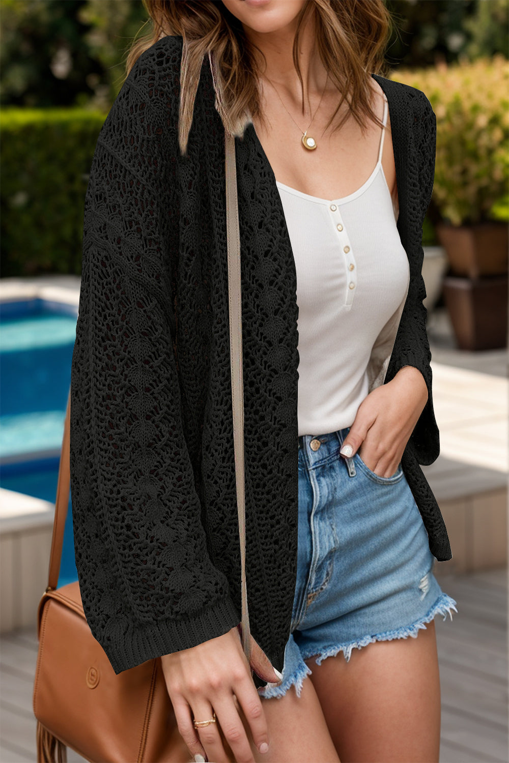 Black open-knit crochet cardigan with long sleeves and a relaxed fit.