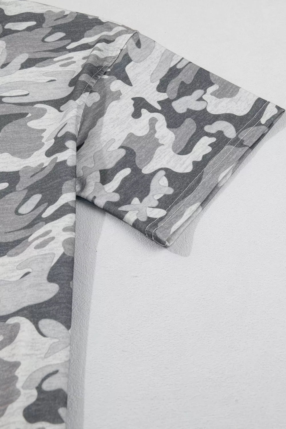 Gray camouflage relaxed fit V-neck tee with short sleeves.