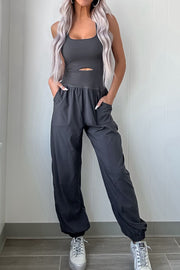 Dark gray cutout bodice gathered-leg jumpsuit with pockets and elastic cuffs.