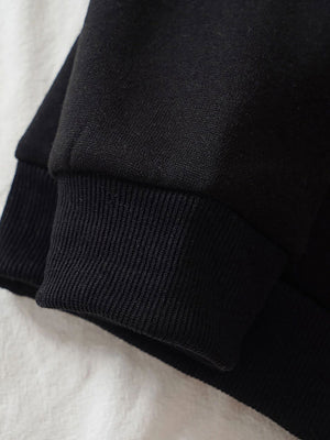 Black hoodie cuff and ribbed hem detail