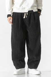 Black corduroy wide-leg cargo pants with drawstring waist and relaxed fit.