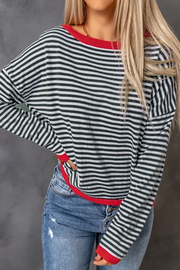 Striped knit crewneck sweater with red contrast trim and crew neckline.