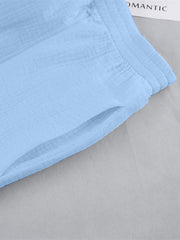 Light blue textured cotton lounge shorts with a pocket and elastic waistband