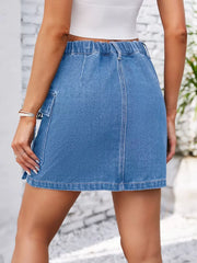 Denim utility skirt in dusty blue with cargo pocket detail and elastic waistband.