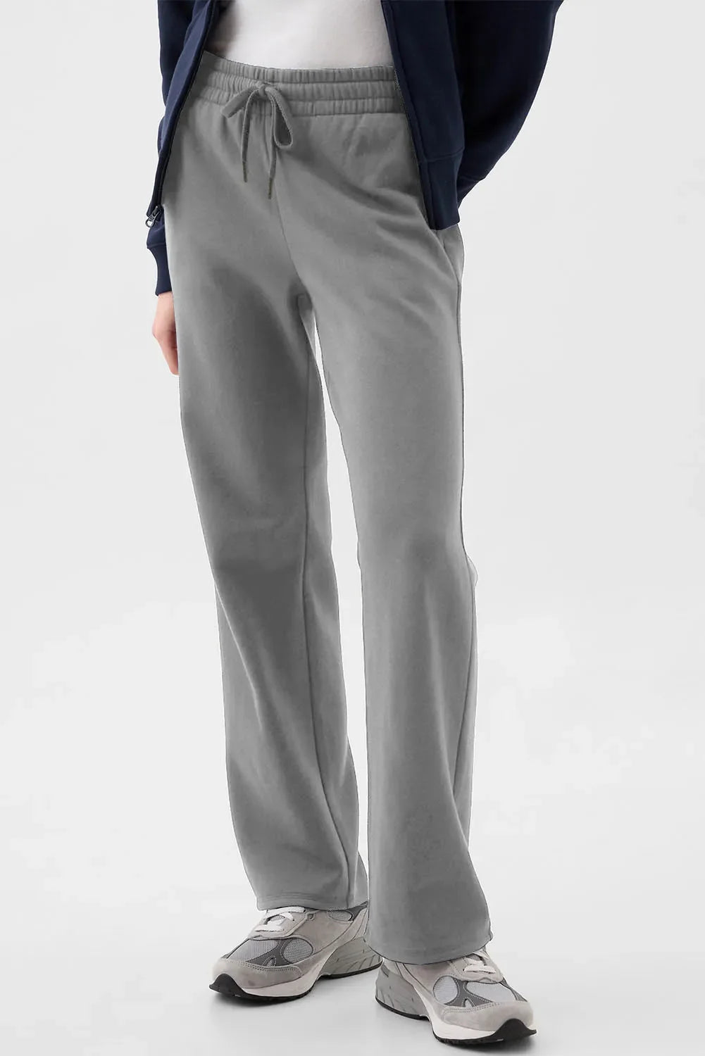 Relaxed-fit lounge trousers in dark gray with drawstring waist and pockets.