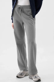 Relaxed-fit lounge trousers in dark gray with drawstring waist and pockets.