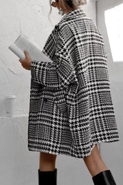 Black and white houndstooth oversized cocoon coat with lapels and pockets.