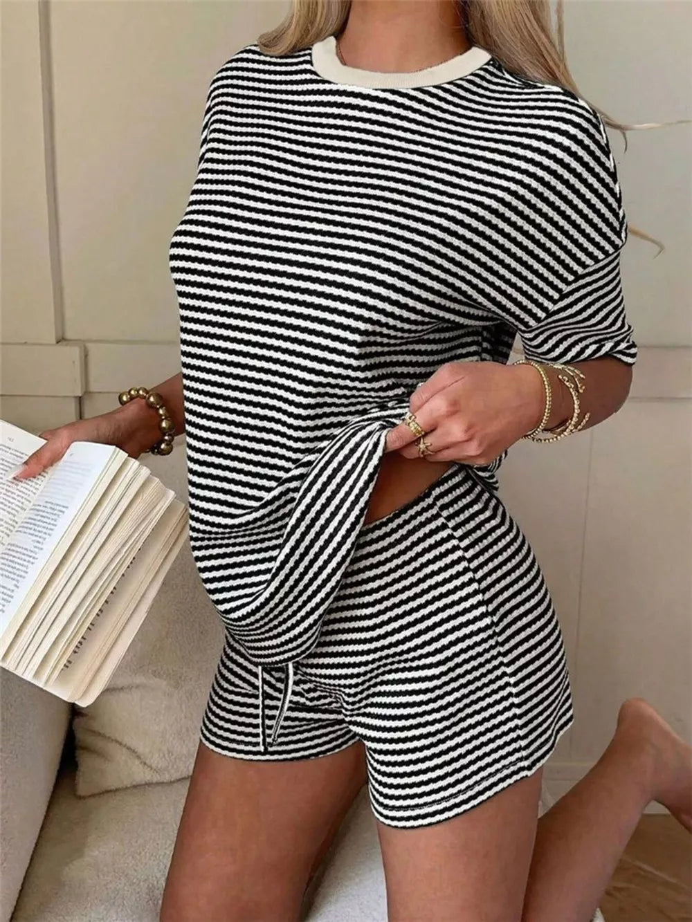 Black and white striped two-piece set with drawstring shorts and crew neck top.