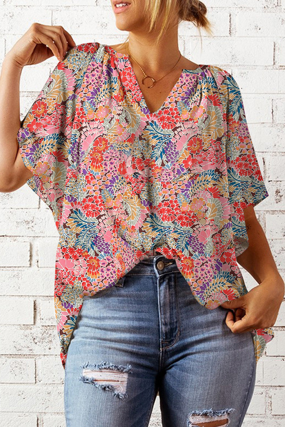 Floral dolman sleeve v-neck blouse with a colorful bloom pattern.