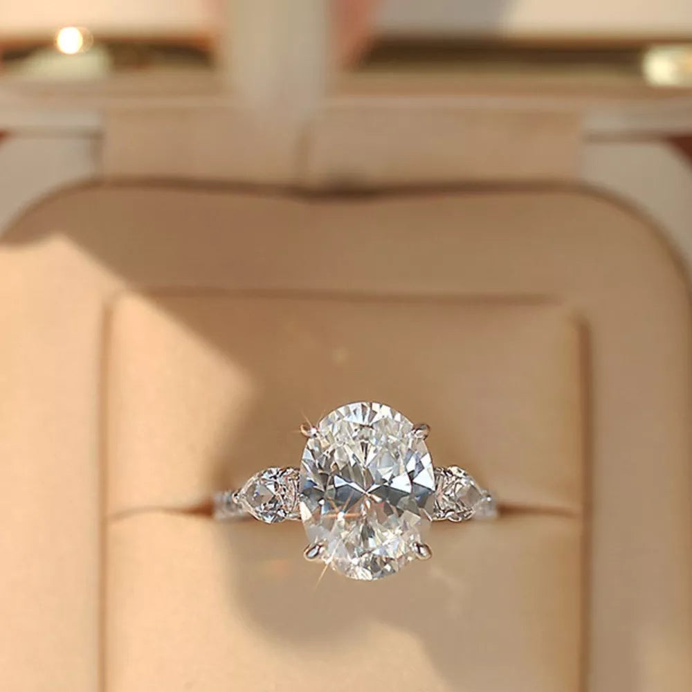 Dazzling Moissanite oval ring in sterling silver with side stones