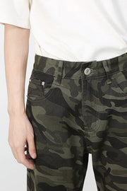 Camo flare denim trousers in green camouflage pattern with a button fly.
