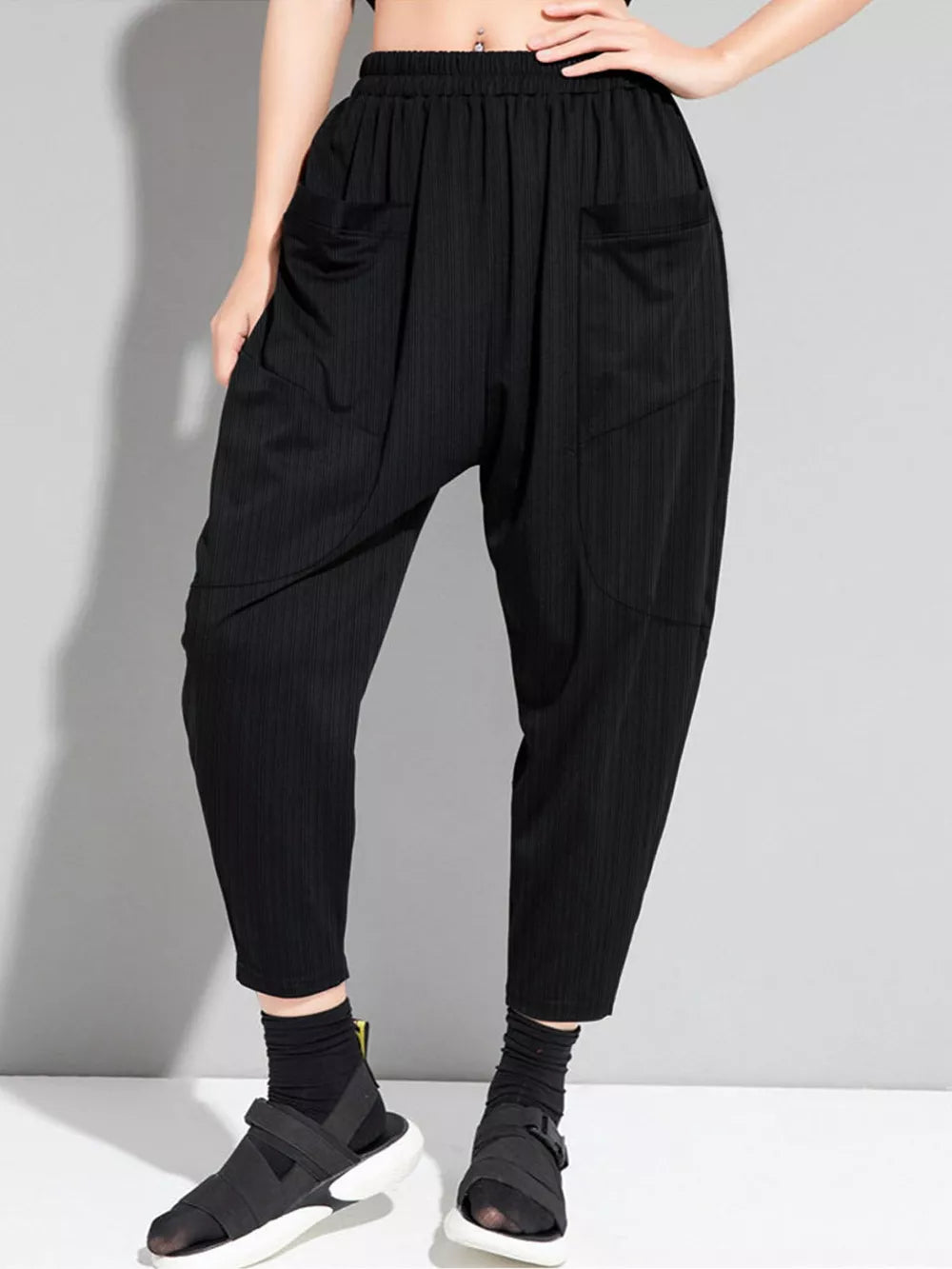 Black pinstripe harem maternity pants with elastic waist and pockets.