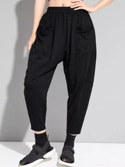 Black pinstripe harem maternity pants with elastic waist and pockets.