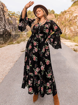 Black floral viscose maxi dress with bell sleeves and a ruffled hem.
