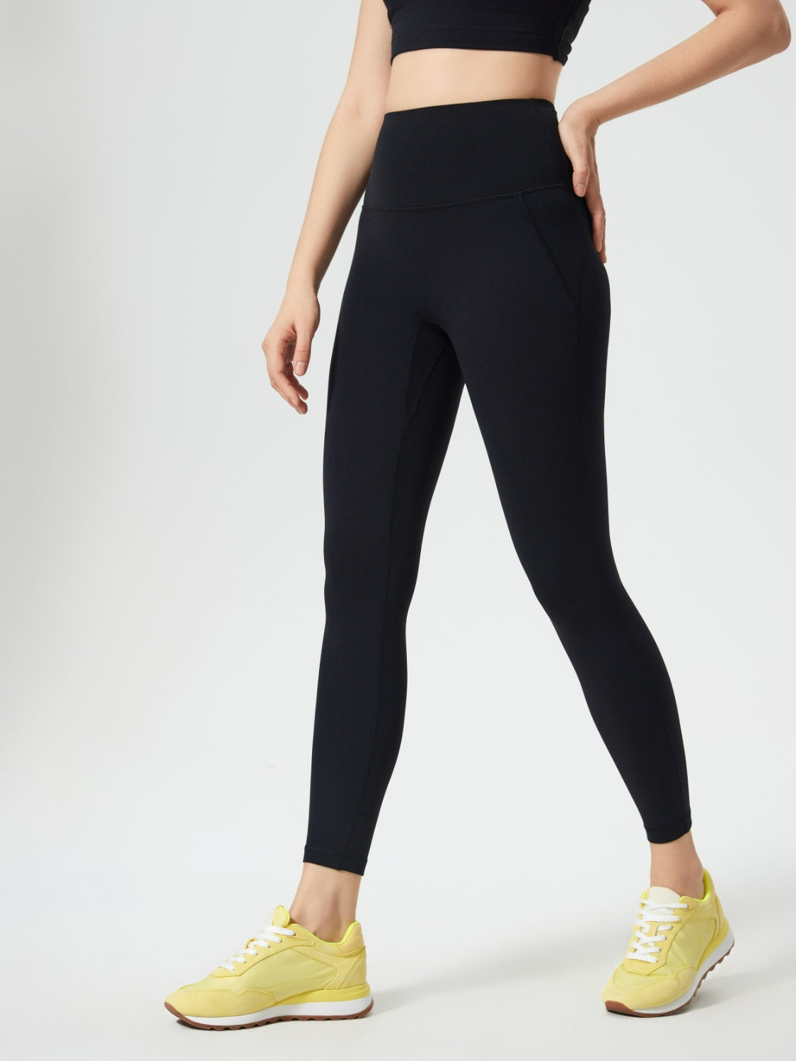 Black high-waisted leggings with subtle pocket detail and a sculpted fit.